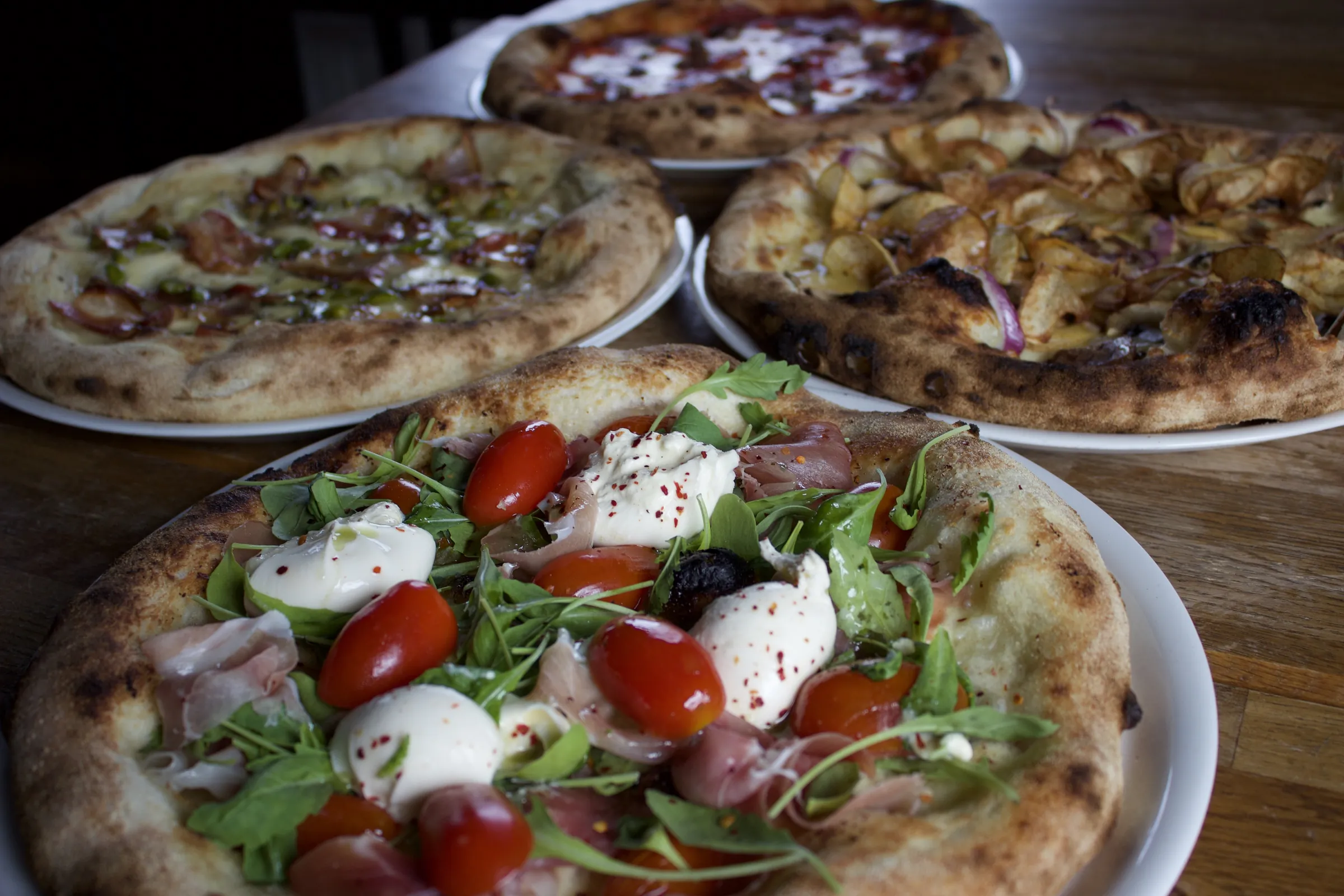 Wood-fired pizzas from Pizzasmiðjan on the table
